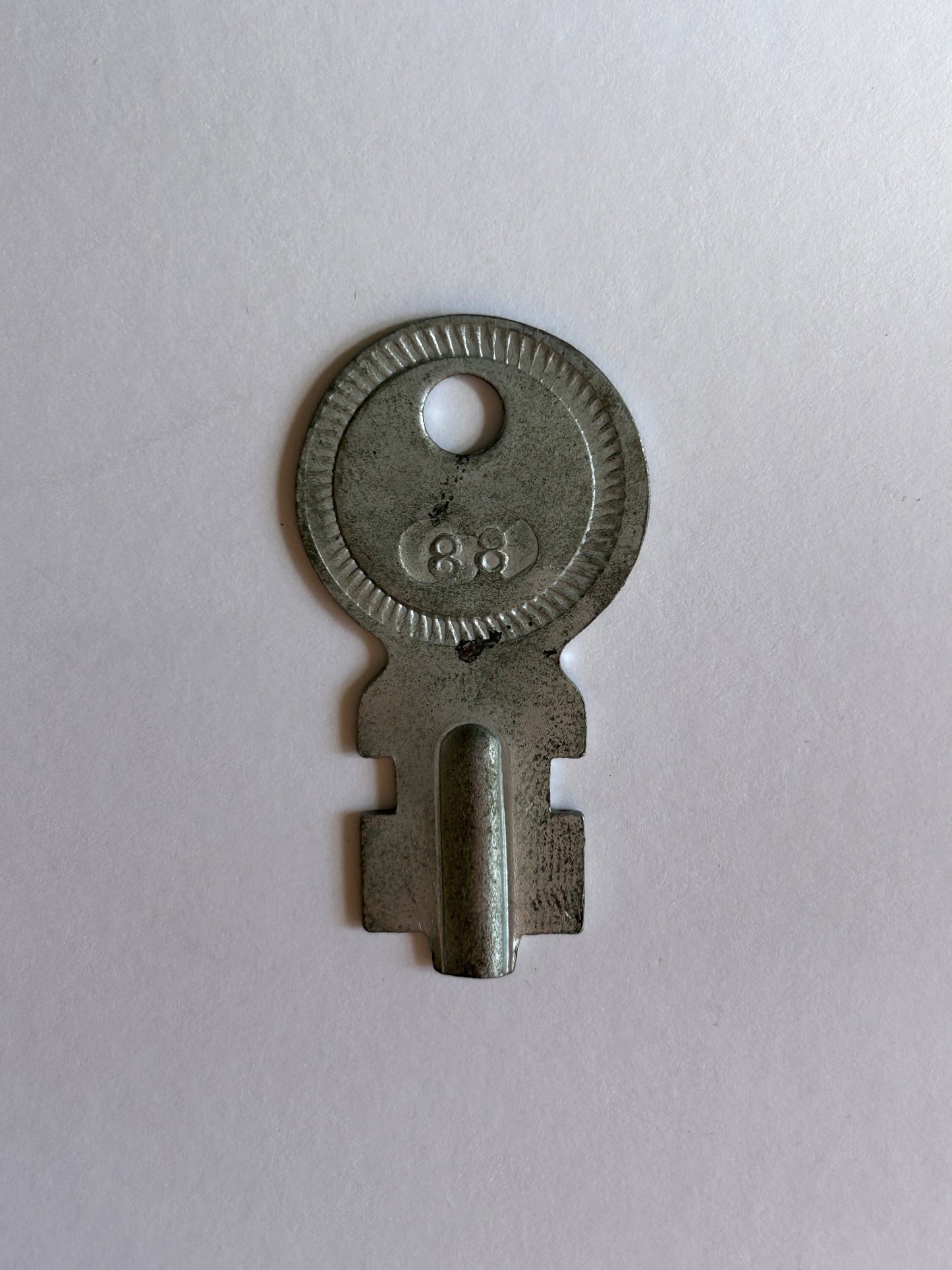 Metal key on a light gray background