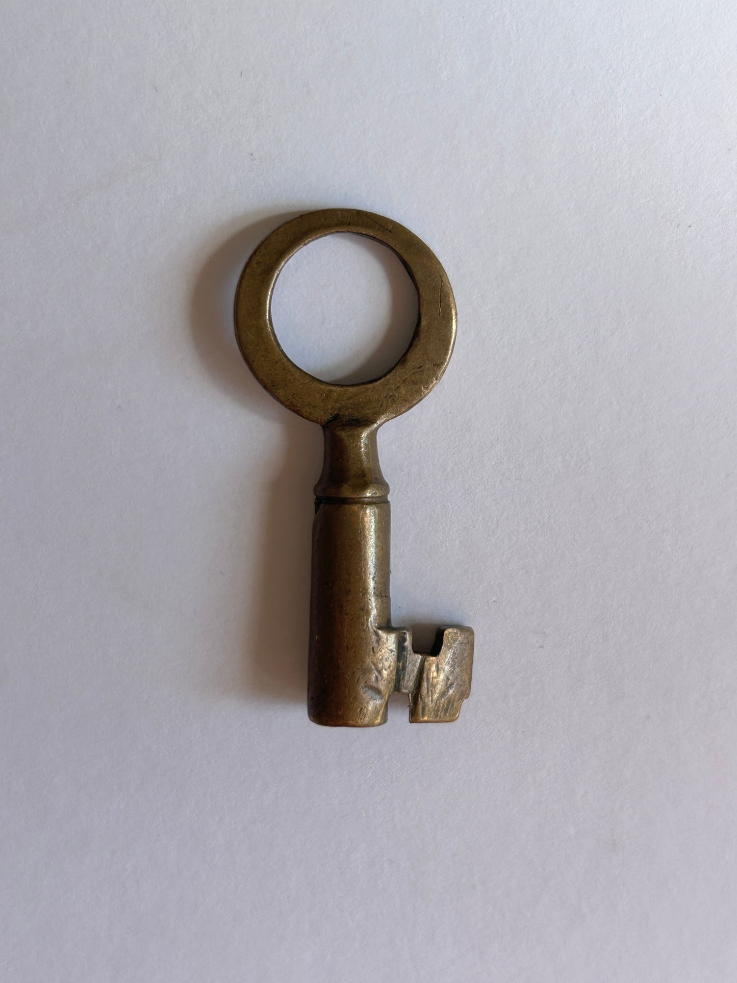 Vintage brass key on a white background